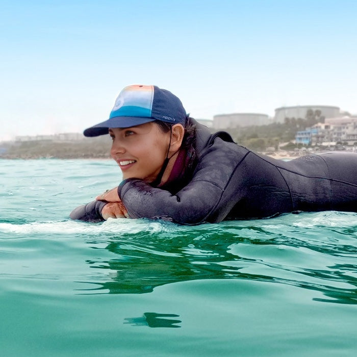 Surfer girl wearing a surf cap