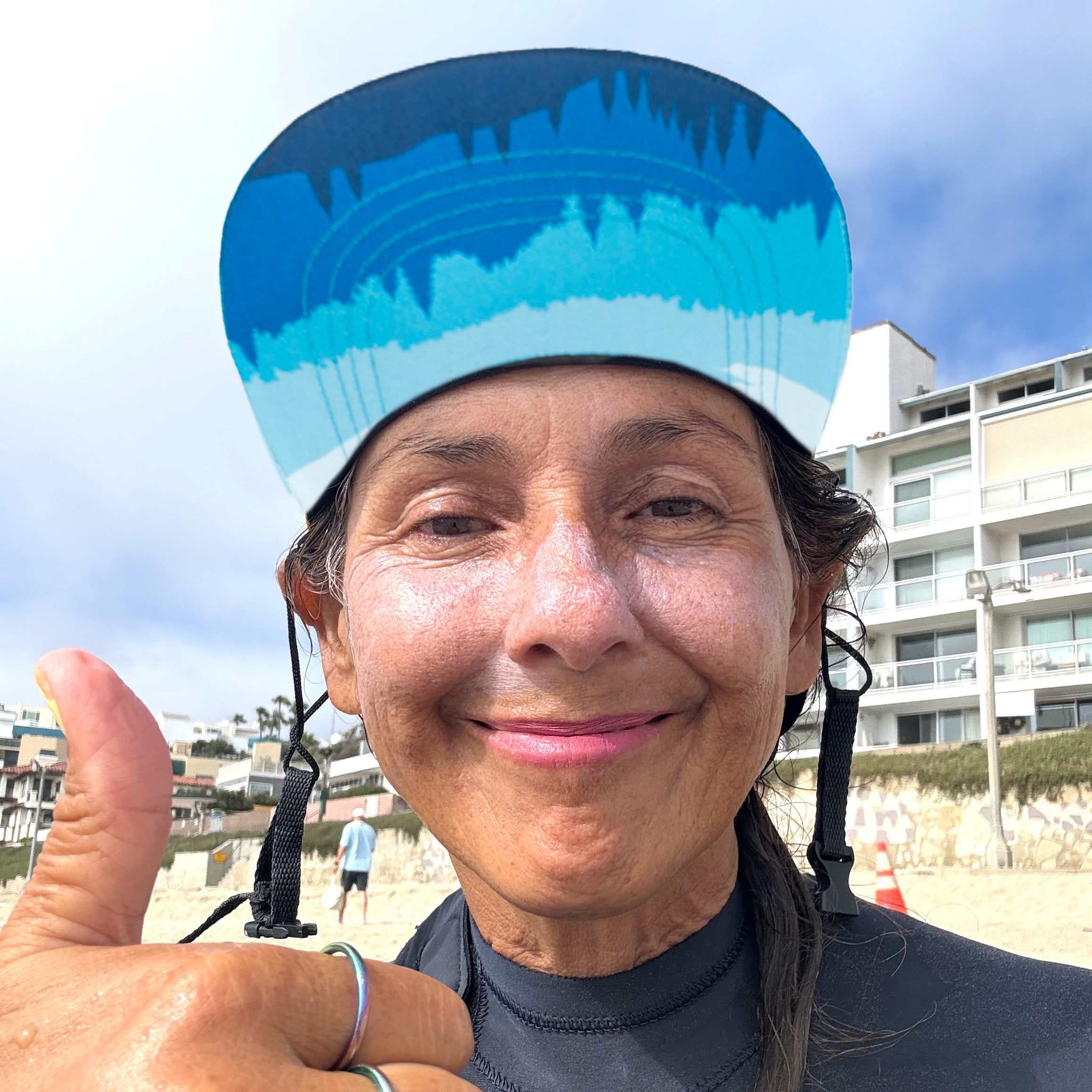 Surfer girl wearing a surf hat that can flip up